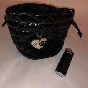 “Guess” coin or makeup pouch.